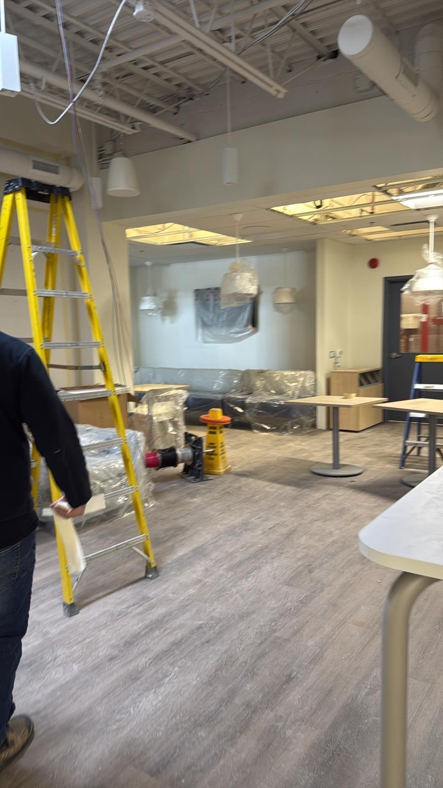 Commercial break room being readied after construction with appliances and furniture protected